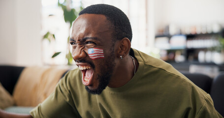Naklejka premium Black man, celebration and USA flag on sofa with face paint, cheers and goals in global soccer competition. Person, happy and excited with success, winning or watching tv for football at apartment