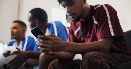 Hands, phone and watching tv with friends for football, game and texting with streaming service. Men, group and smartphone with scroll, typing and notification on mobile app with soccer fans at home © peopleimages.com
