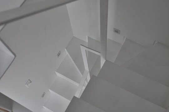 Graphic white stair geometry from top view in minimal interior