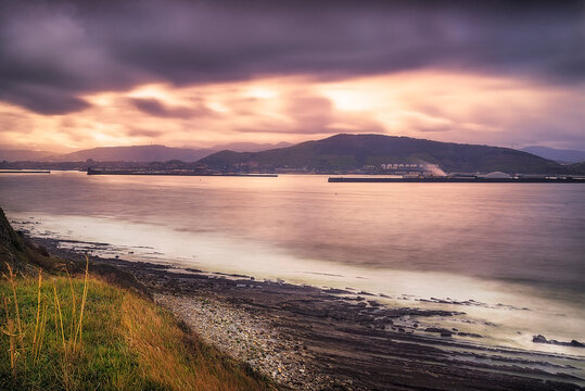 Panoramic view of Serantes mountain and Bilbao port at sunset from La Galea coast in Getxo, Spain