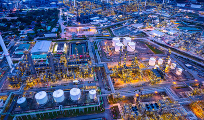 Oil refinery. Aerial view of oil and gas industry refinery. Petrochemical plant area and oil storage tank energy concept during the evening energy concept © Media 