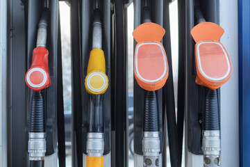 Fuel nozzles line up in petrol station dispenser, highlighting energy supply, vehicle service, consumer choice and transport use. © SOLDATOOFF