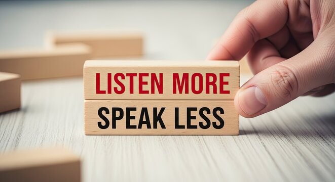 Wooden blocks with motivational message listen more speak less