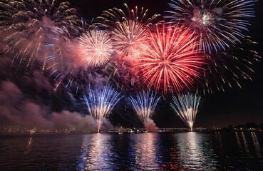 Fototapeta premium Fireworks display night sky celebration vibrant colors exploding over dark water high resolution photo