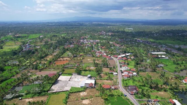 Aerial drone footage of Tasikmalaya city horizon, with a main road nearby Galunggung volcano mountain, in the morning, forests, villages around, in Tasikmalaya regency, Java island, Indonesia