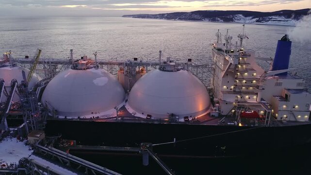 Aerial close-up of an aft of Liquified Natural Gas LNG carrier moored to a small gas terminal. Fuel crisis. Sanctions