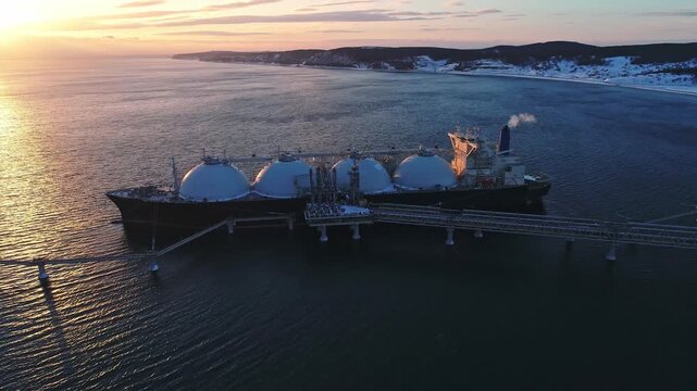 Aerial of Liquified Natural Gas LNG carrier moored to a small gas terminal. Fuel crisis. Sanctions