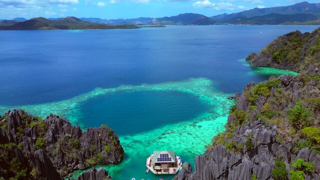 Palawan limestone karsts and clear turquoise water. Smooth aerial view drone