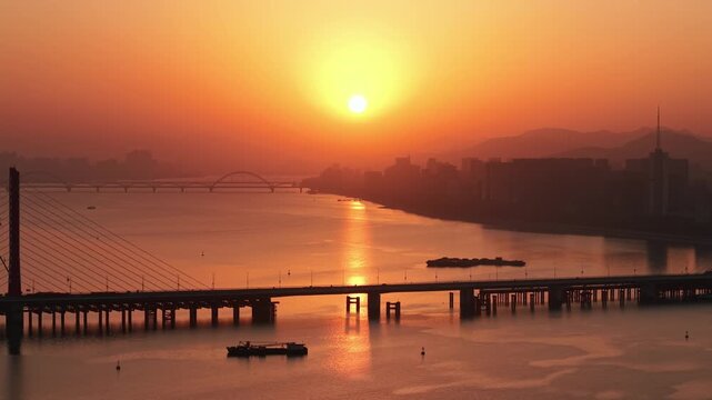 Golden hour over Qian Tang River and Bridges with Hangzhou Cityscape at Sunset