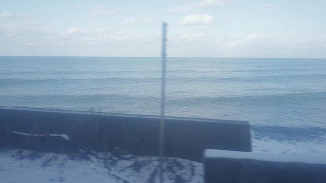 Winter travel concept, beautiful sea view from a train