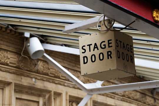 Stage door sign on theater exterior building