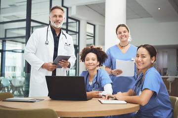 Fototapeta premium Portrait, doctor and nurses in hospital with teamwork, laptop and manager help for medical research. Happy, people and healthcare workers in clinic with computer, expert advice and pride for service.