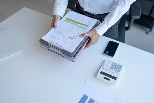 Businessman holding a lot of documents paper work concept