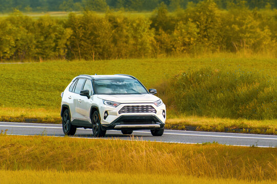 Hybrid SUV from Japan crossing rural landscape