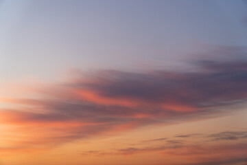 Fototapeta premium Majestic real sunrise sundown sky background with gentle colorful clouds. Panorama of cloudscape at sunset with vivid and dreamy colors on sky. A vibrant sunset sky painted in hues of orange pink. 
