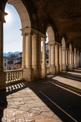Obraz premium Interior view of the upper loggia of the Basilica Palladiana showing the iconic Palladian window arches and light shadows in Vicenza, Italy 08.01.2026