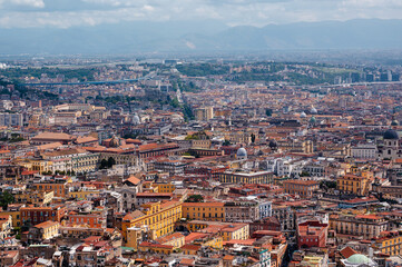 Obraz premium Panoramic view of the dense urban landscape of Naples, Italy, under a cloudy sky