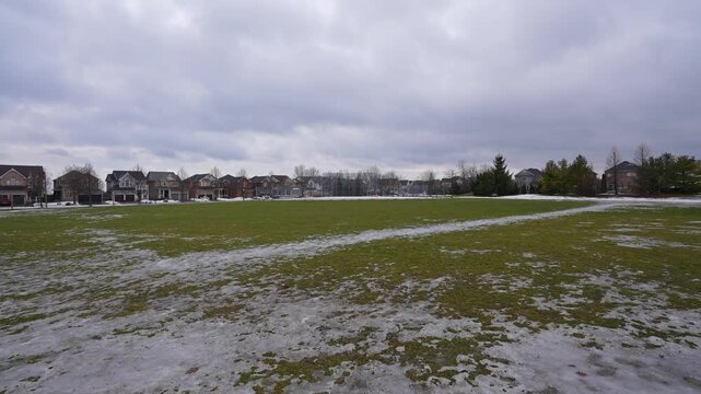 Field Covered with Patchy Ice and Snow at Kinross Park Oshawa Ontario Canada