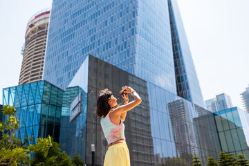 Fototapeta premium girl taking photo. Summer outdoor lifestyle, portrait of young beautiful woman having fun and enjoying vacation, traveling with camera.