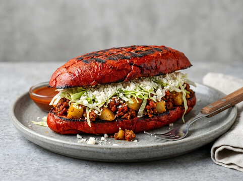 Authentic Mexican Pambazo Sandwich Soaked in Red Guajillo Sauce