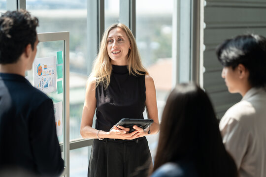 Caucasian business woman giving flipchart presentation in the office