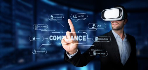 A businessman in a suit interacts with virtual compliance elements, exploring rules, regulations,...