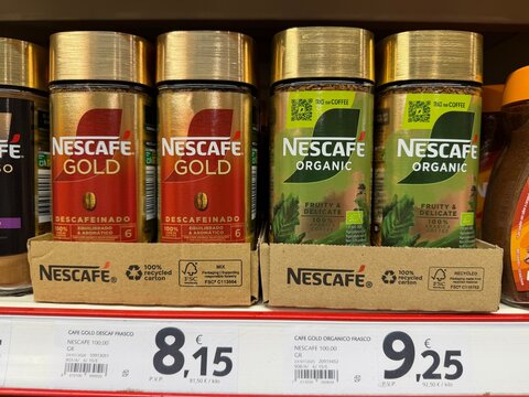 Palmanova, spain, march 26, 2026 nescafe gold decaffeinated and nescafe organic instant coffee jars displayed on supermarket shelf with prices