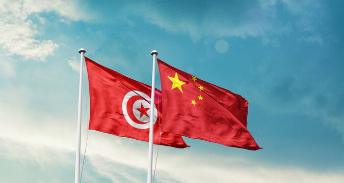 Tunisia and China friendship flags are waving in the sky. Double country Flag waving with mast. Tunisia china national flag for agreement.