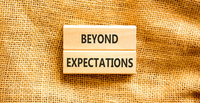 Beyond expectations words symbol. Concept words Beyond expectations on beautiful wooden blocks. Beautiful canvas background. Business and Beyond expectations words concept. Copy space.