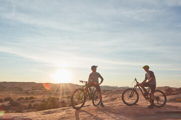Fototapeta premium People, mountain bike or relax in nature with scenic view, adventure or endurance training for fitness. Space, friends and cycling break with bicycle, helmet or sunshine outdoor for exercise together