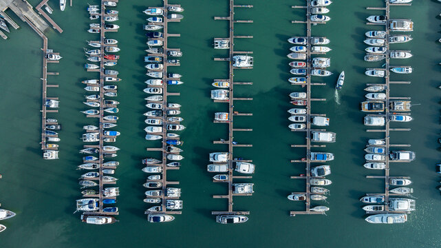 Aerial view of colorful yatch boats, Summer seascape with ships, sunny day. Top view, yachts from flying drone, Aerial view directly above of Yatchs moored at the quay.