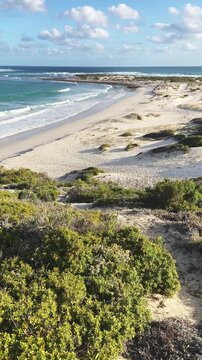 4k 60p vertical footage of dramatic coastal view to Struis Point (Struispunt) and Saxon Reef from the cliffs near Waenhuiskrans Cave, Arniston. Turquoise Overberg waters, Western Cape, South Africa.