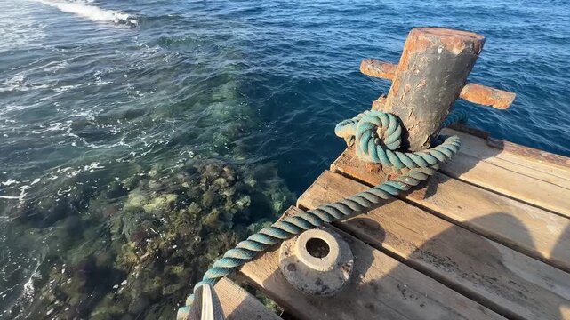 Clear red sea water with coral reefs and dock bollard