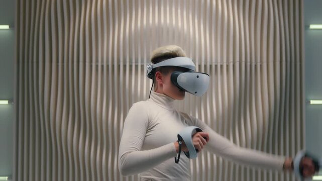 White futuristic space Caucasian woman female girl in VR glasses helmet 3d playing pretend kick hologram hold joystick kicking in air gaming play virtual reality metaverse future innovative technology