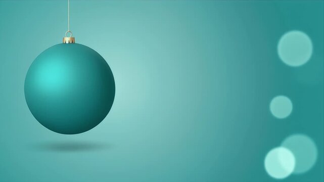 Hanging Teal Glass Ornament with Soft Reflections in Minimalist Studio Lighting