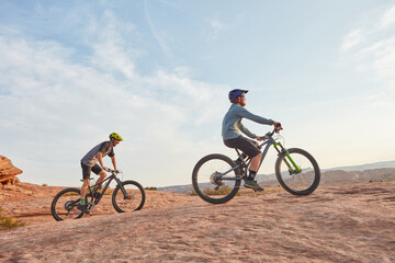 Obraz premium People, exercise and cycling in nature with mountain bike, adventure and training together for fitness. Space, friends and countryside journey with bicycle, helmet and outdoor workout for wellness.