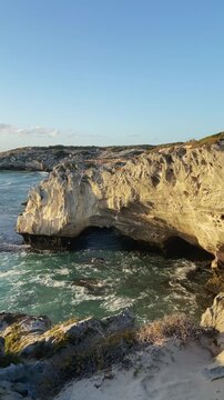 4k 60p vertical footage of the rocky coastline near Waenhuiskrans Cave, Arniston. Towering cliffs meet ocean waves in Overberg seascape, Western Cape, South Africa. Ideal for nature and travel visuals