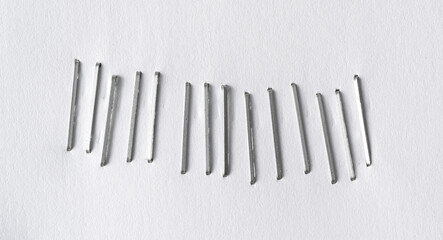 Fototapeta premium Staples pushed into a paper, metal office staple needles