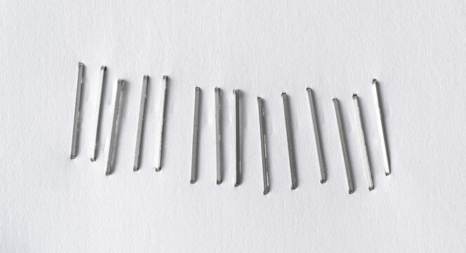 Staples pushed into a paper, metal office staple needles