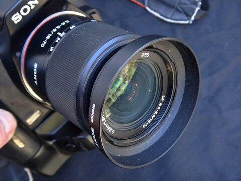 Sony DSLR camera with 18-70mm lens and sun hood