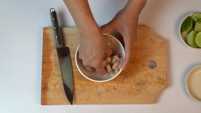 Marinating Fresh Raw Shrimps in a Bowl with Lime and Salt