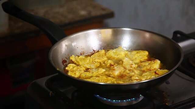 Season chicken breast fillet being cooked on a frying pan