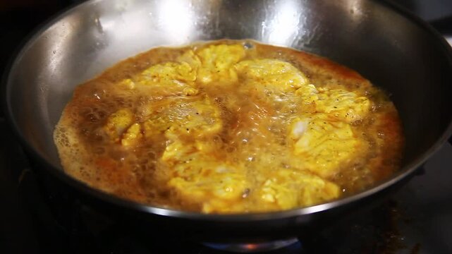 Season chicken breast fillet being cooked on a frying pan