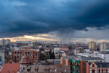 Obraz premium Rain shaft and dramatic storm clouds over European city skyline