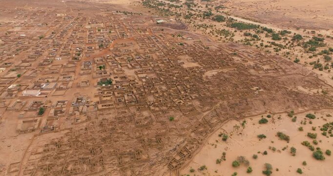 Ancient Fortified Town Of Ouadane, Mauritania, With Mud-brick Buildings In Sahara Desert Landscape. aerial shot