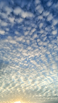 Blue sky with white puffy clouds, beautiful sky background texture. Clean air and clouds