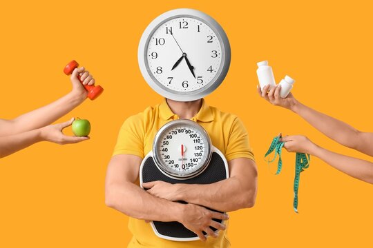 Man with clock instead of his head and hands holding different things on yellow background. Intermittent fasting concept