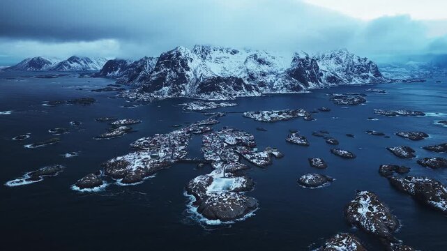 Aerial view of the Henningsv&aelig;r Football Stadium and surrounding islands, where the dark ocean contrasts with the snow-covered landscape, Henningsv&aelig;r, Nordland, Norway.