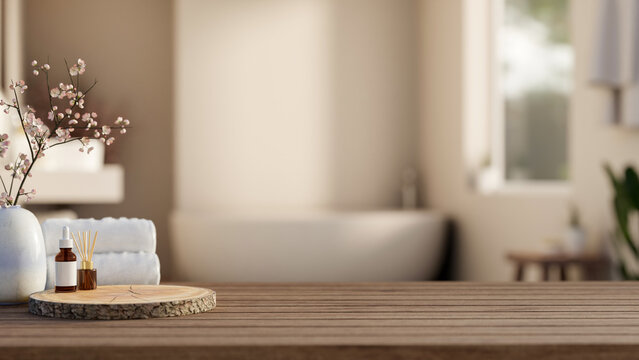 Serum skincare and diffuser on round log tray with white towels on wooden counter table in bathroom.