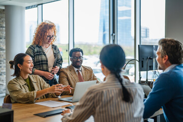 Fototapeta premium Diverse business team collaborating in modern office meeting